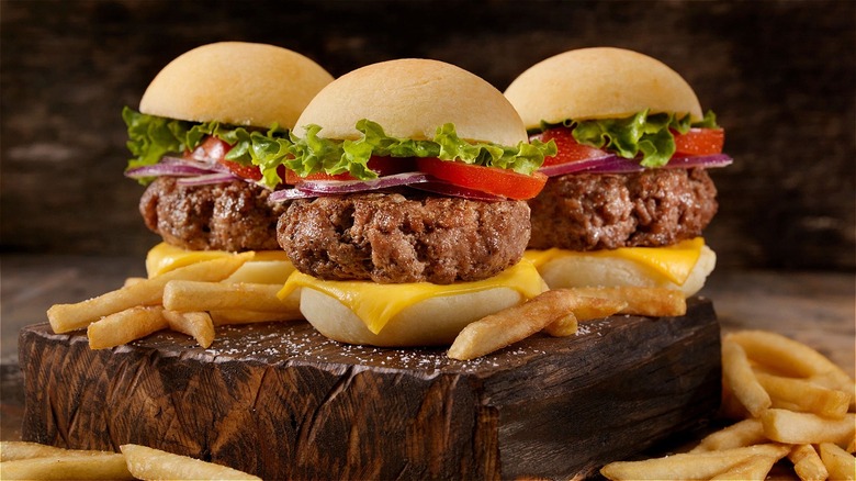 Three slider burgers with fries
