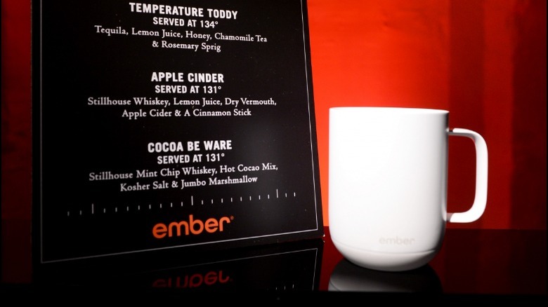 Ember coffee mug next to a menu 