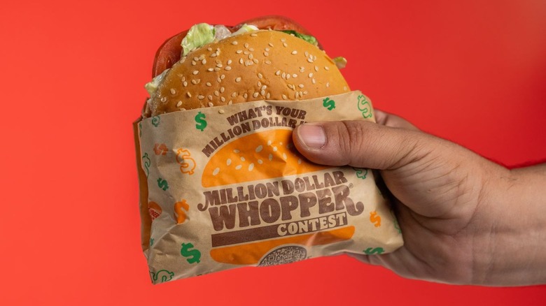 Hand holding Million Dollar Whopper