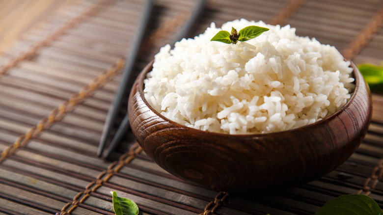 cooked rice in bowl over bamboo mat