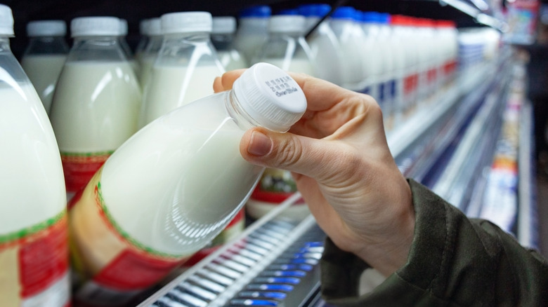 Woman grabs milk jug