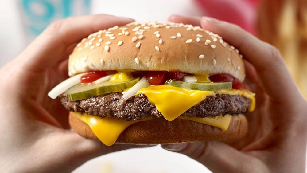 Hand holding McDonalds burger