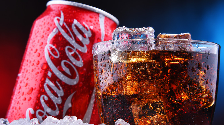 Coca-Cola can and glass with ice