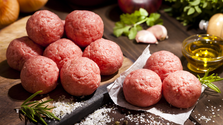 raw meatballs on a cutting board