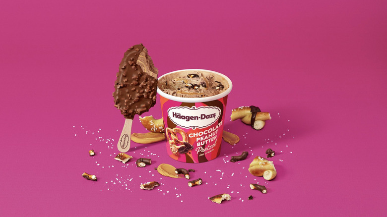 Häagen-Dazs pint and ice cream bar on pink background