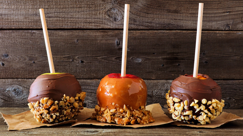 Three candy apples with chocolate and caramel