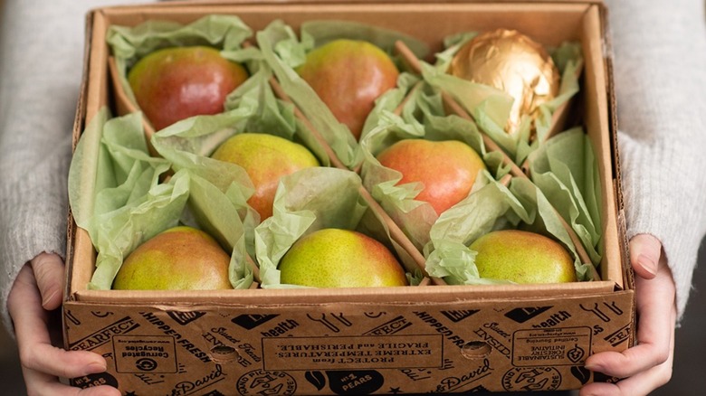 Pears in a box with green tissue paper