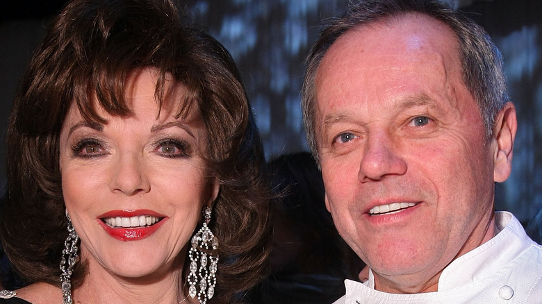 Joan Collins and Wolfgang Puck smiling