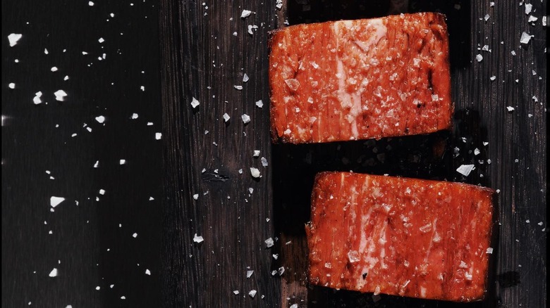 two cooked pieces of Juicy Marbles' plant-based filet mignon with salt flakes