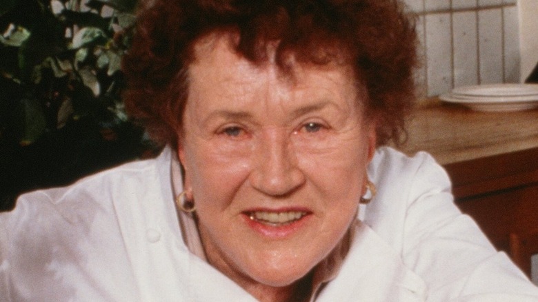 Julia Child smiling with flowers