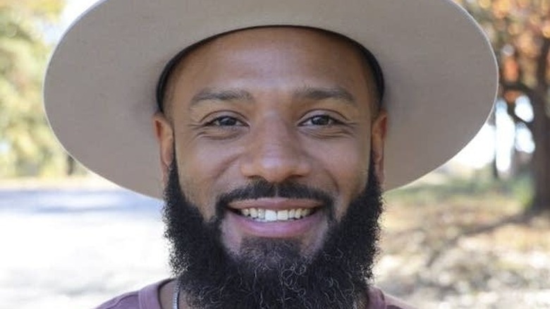 Justin Sutherland smiling in hat