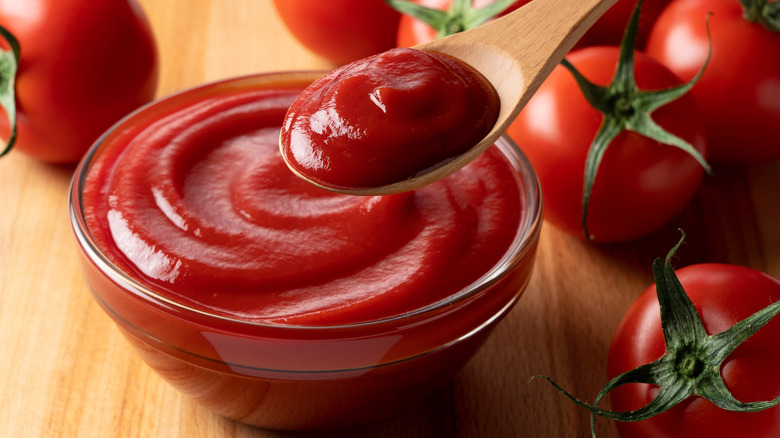 Wooden spoon scooping ketchup