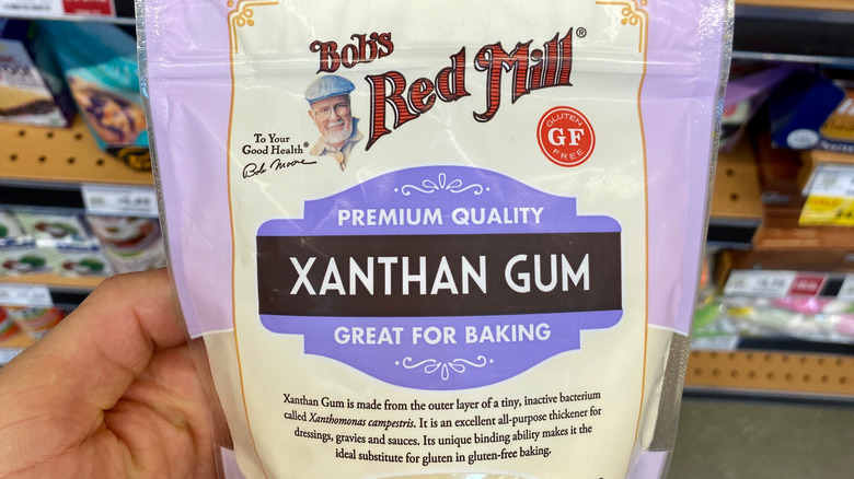 Hand holding bag of xanthan gum