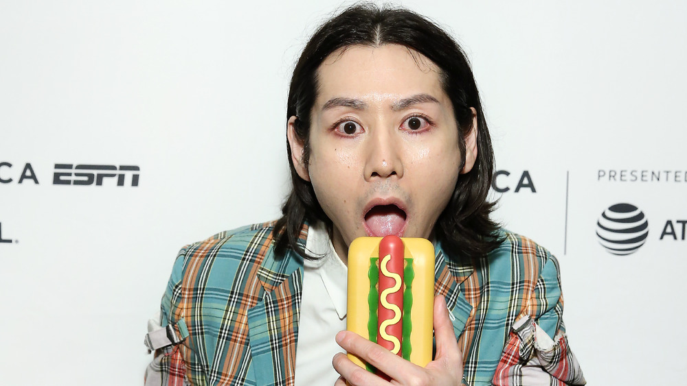 Takeru Kobayashi pretending to eat a fake hot dog