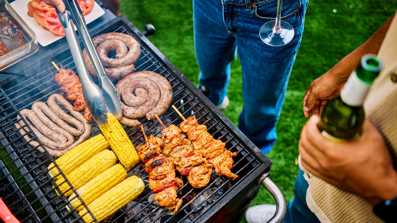 Meat and corn on the cob on grill