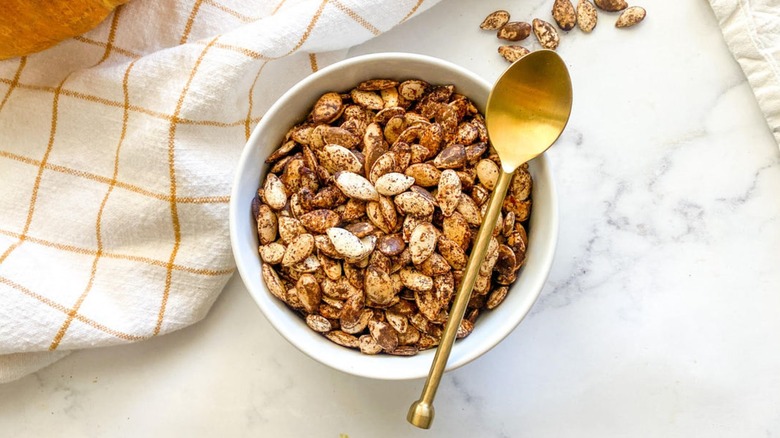 roasted pumpkin seeds in a bowl with spoon