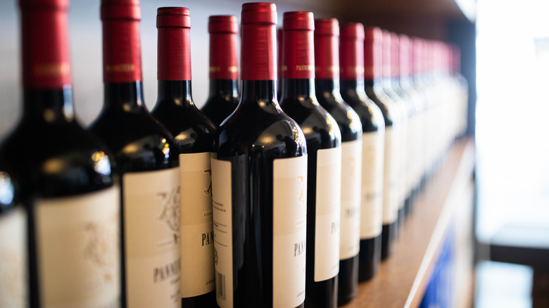 Red wine bottles on shelf