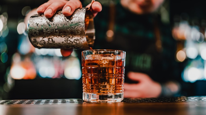 Bartender pouring vermouth cocktail