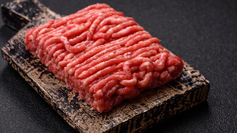 Ground beef on wooden board