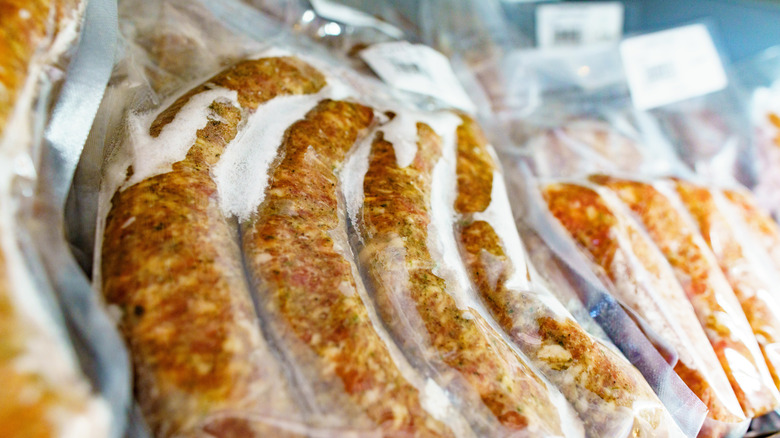 Packaged pork sausages in a freezer
