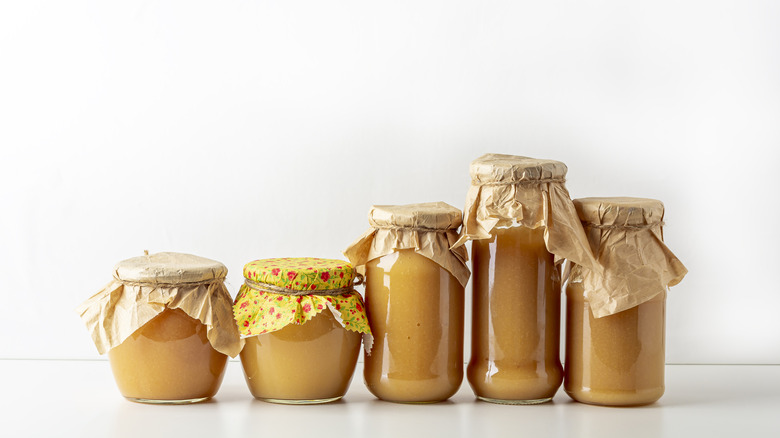 Row of airtight containers filled with applesauce