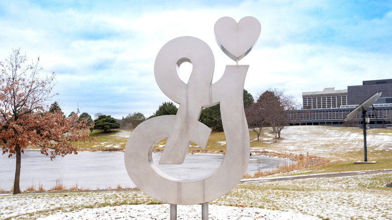 close up of a hand holding a smart phone with the General Mills logo on it