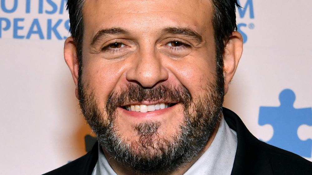 Adam Richman smiling on red carpet