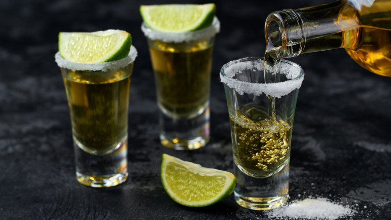 Pouring shots of tequila with salt and lime