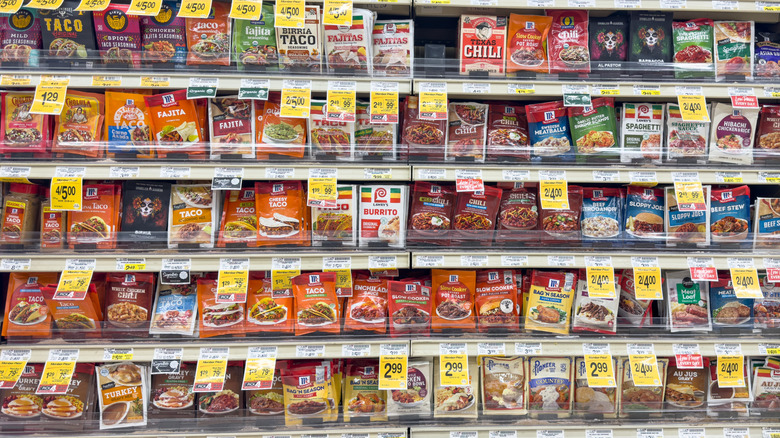 Shelves lined with different taco seasonings at the grocery store.