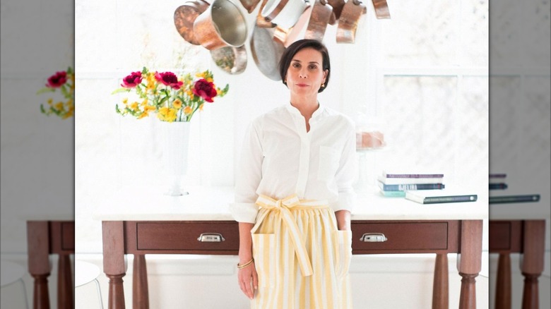 Melissa Baldino posing seriously in one of her business aprons