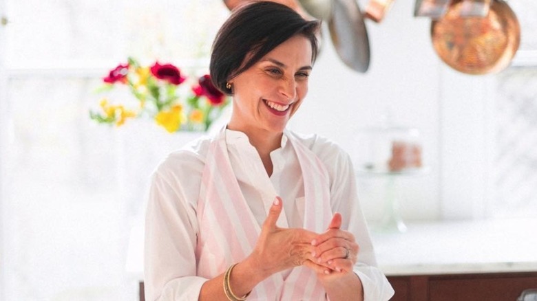 Melissa Baldino smiling while clasping her hands
