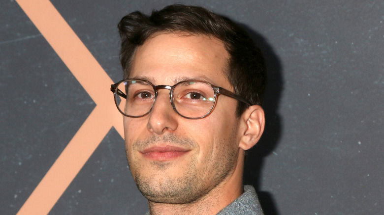 Andy Samberg with glasses and slight smile