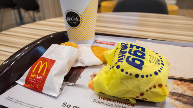 Wrapped egg McMuffin, two hash browns, and a coffee