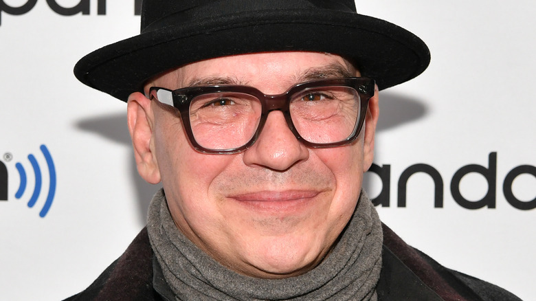 Michael Symon wears hat and glasses