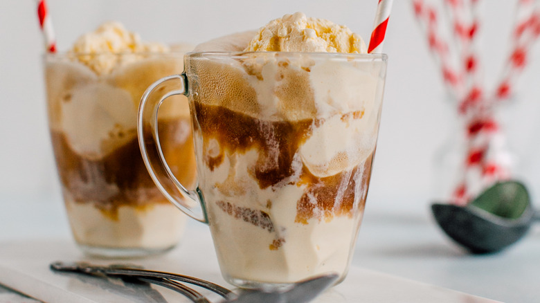 two root beer floats in mugs with handles