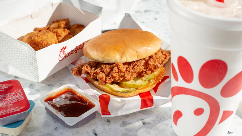 Chick-fil-A chicken sandwich with nuggets, sauces, and drink