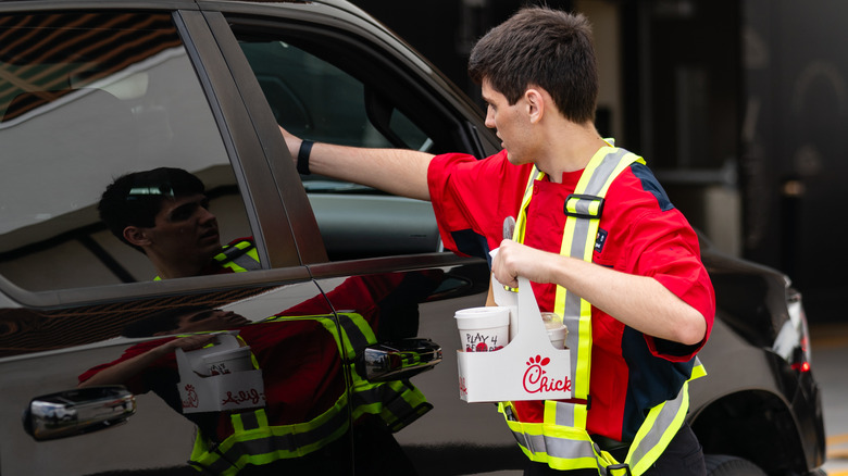 Chick-fil-A employee giving a customer their food