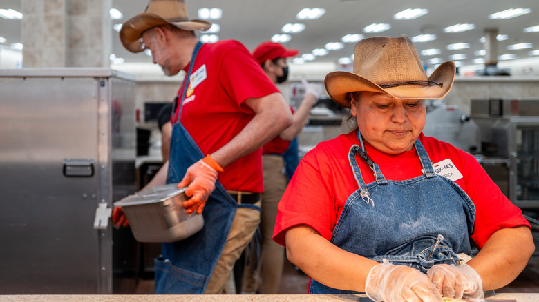 Employees in a kitchen at a Buc-ee's convenience store prepare food
