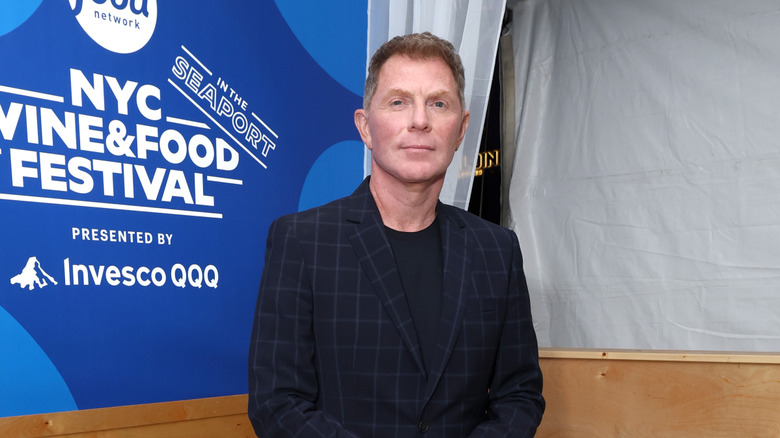 Bobby Flay posing in a suit jacket