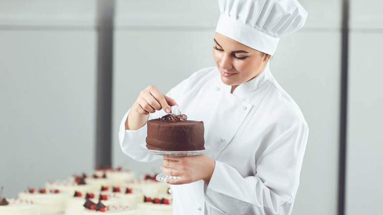 Pastry chef decorating cake