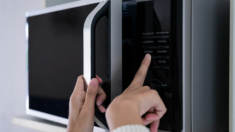 Person operating a microwave