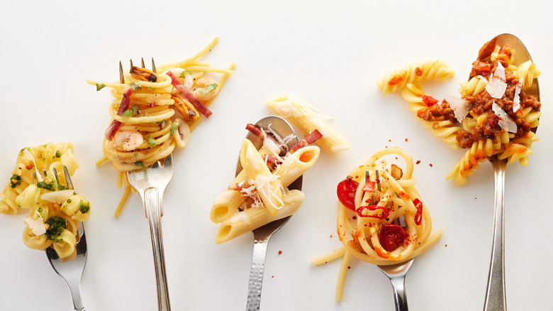 Different kinds of pastas on utensils