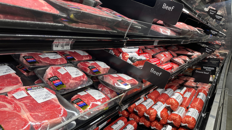 Rows of packaged fresh beef inside a grocery store