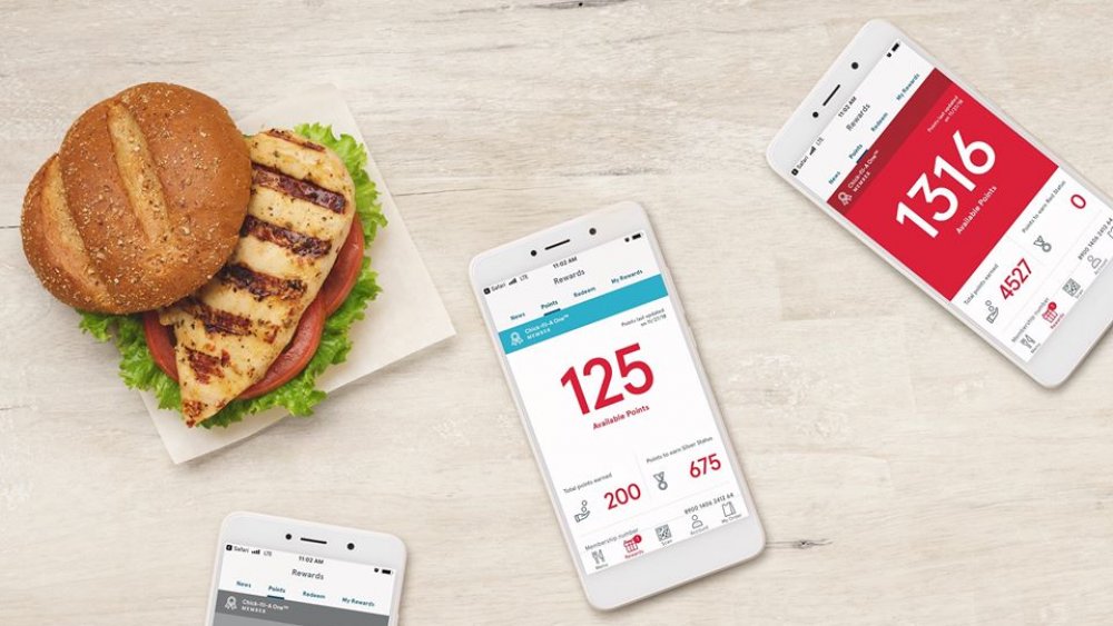 Chick-fil-A grilled chicken sandwich with rewards app open on phones