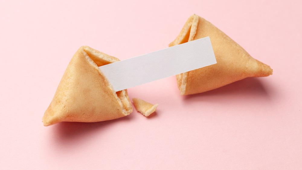 A fortune cookie with pink background