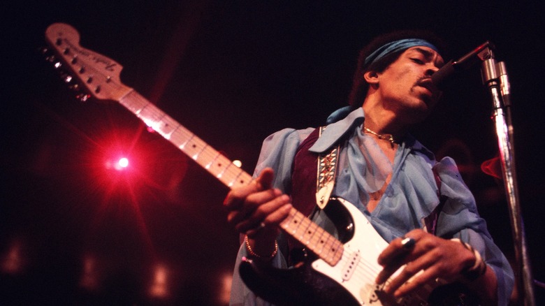 Jimi Hendrix performing onstage at a concert