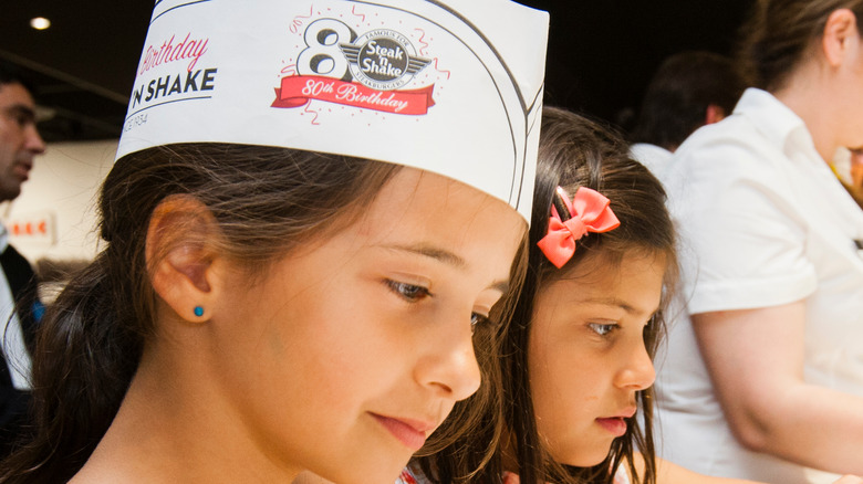 Child in a Steak 'n Shake hat