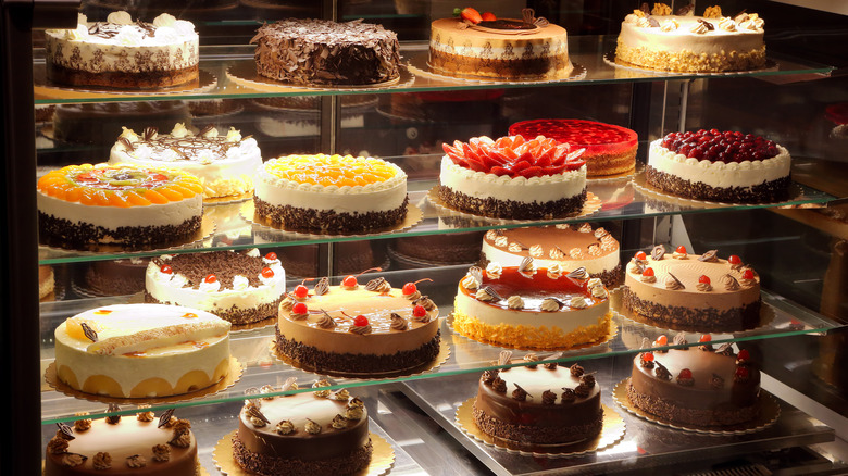 Cakes on glass display shelves
