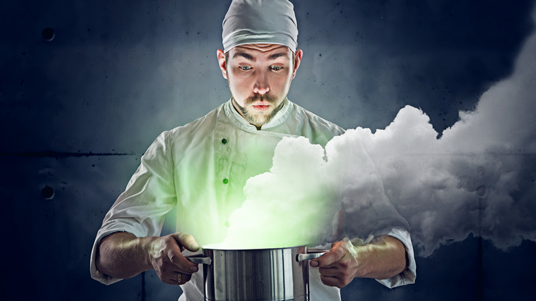 Cook looking into a pot with a mysterious recipe in it