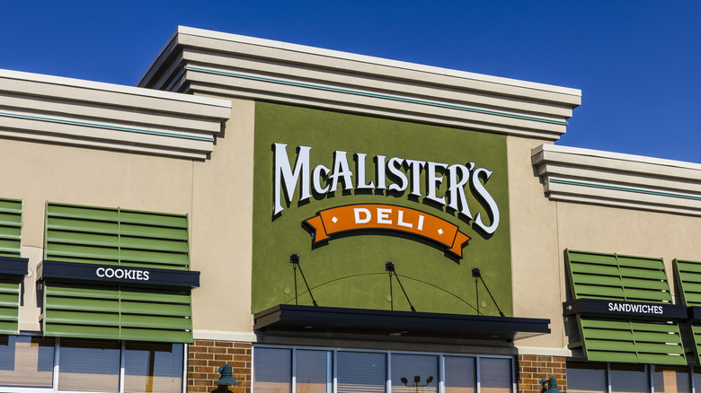 Green, white and orange McAlister's Deli logo on building